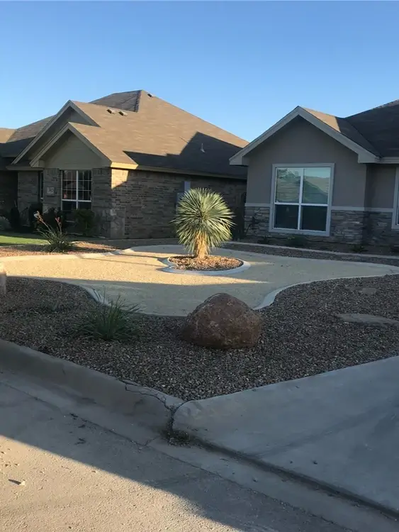 Rock and curbing in front of house