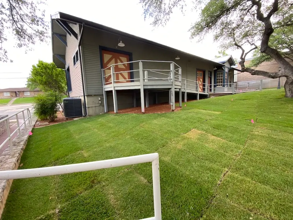 New sod installation on side of house