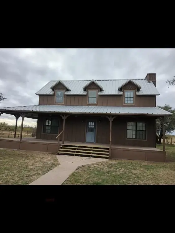 House with outdoor wrap around porch