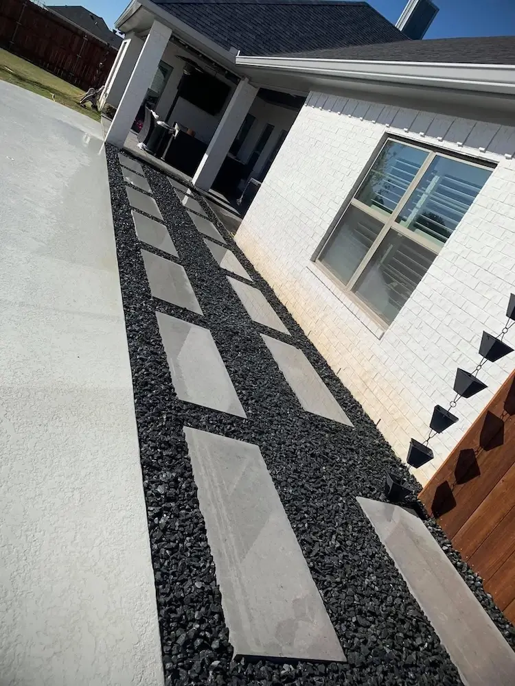 Rock and pavers in front of house
